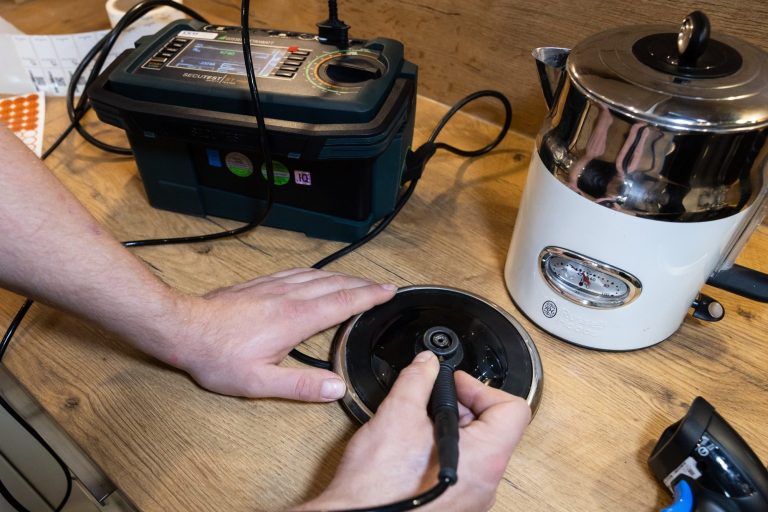 Elektriker führt Geräteprüfung nach VDE 0702 (DGUV V3) durch.
